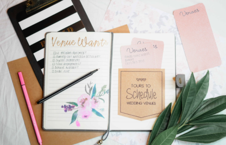 A wedding planner notebook helps couples stay organized while choosing the perfect venue.