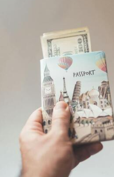 A passport and travel funds symbolize preparation for a destination wedding journey.