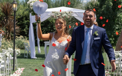 Newlyweds celebrate their “just married” moment, walking down the aisle surrounded by love, joy, and celebration.