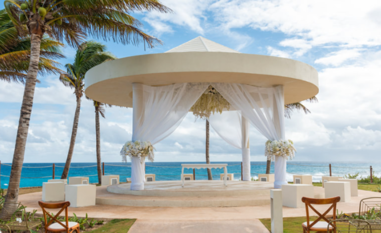 Say “I do” beneath a stunning oceanfront gazebo, framed by flowing drapes and tropical breezes.