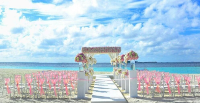 A dreamy beachfront wedding setup with floral arches and ocean views, creating the perfect aisle to forever.