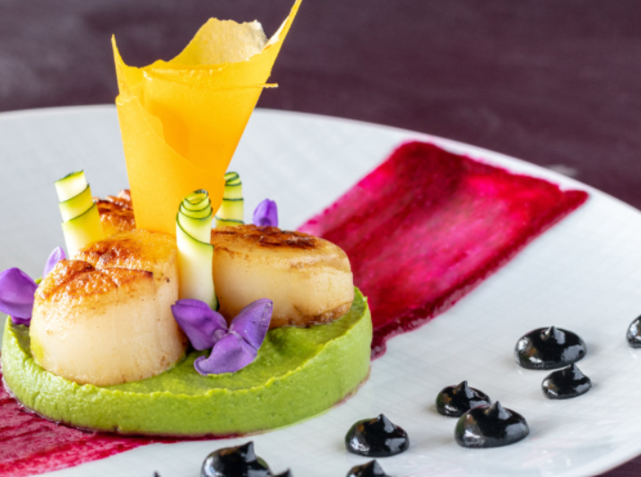 A beautifully plated gourmet dish showcasing culinary artistry and refined flavors in a luxury dining setting.