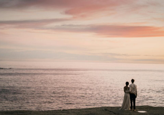 Couple standing by the Beach