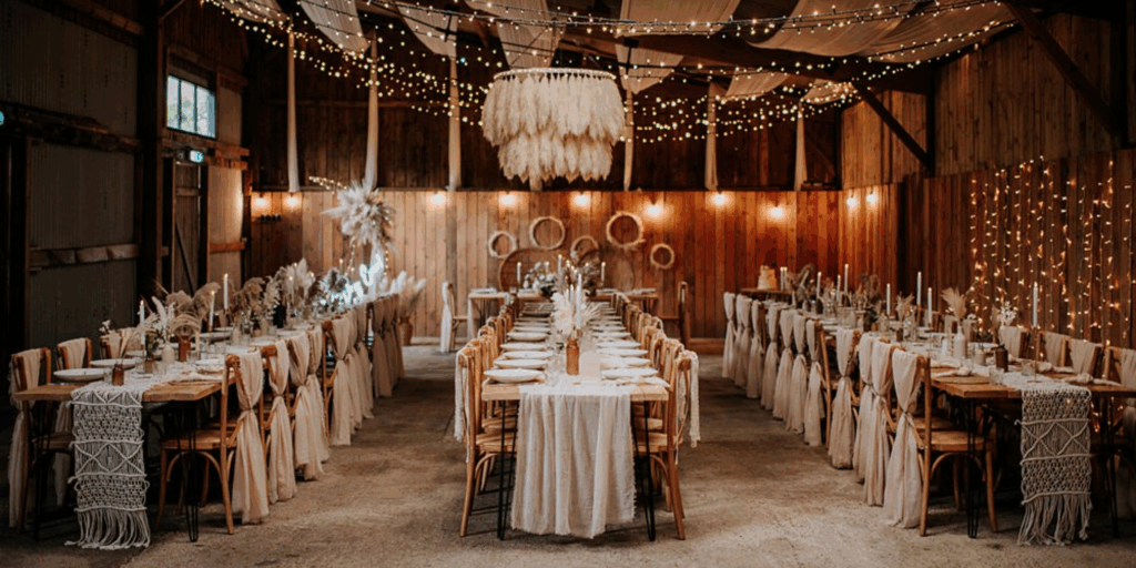 A candlelit wedding reception with soft linens and warm lighting creates an intimate, romantic Valentine’s-inspired atmosphere.