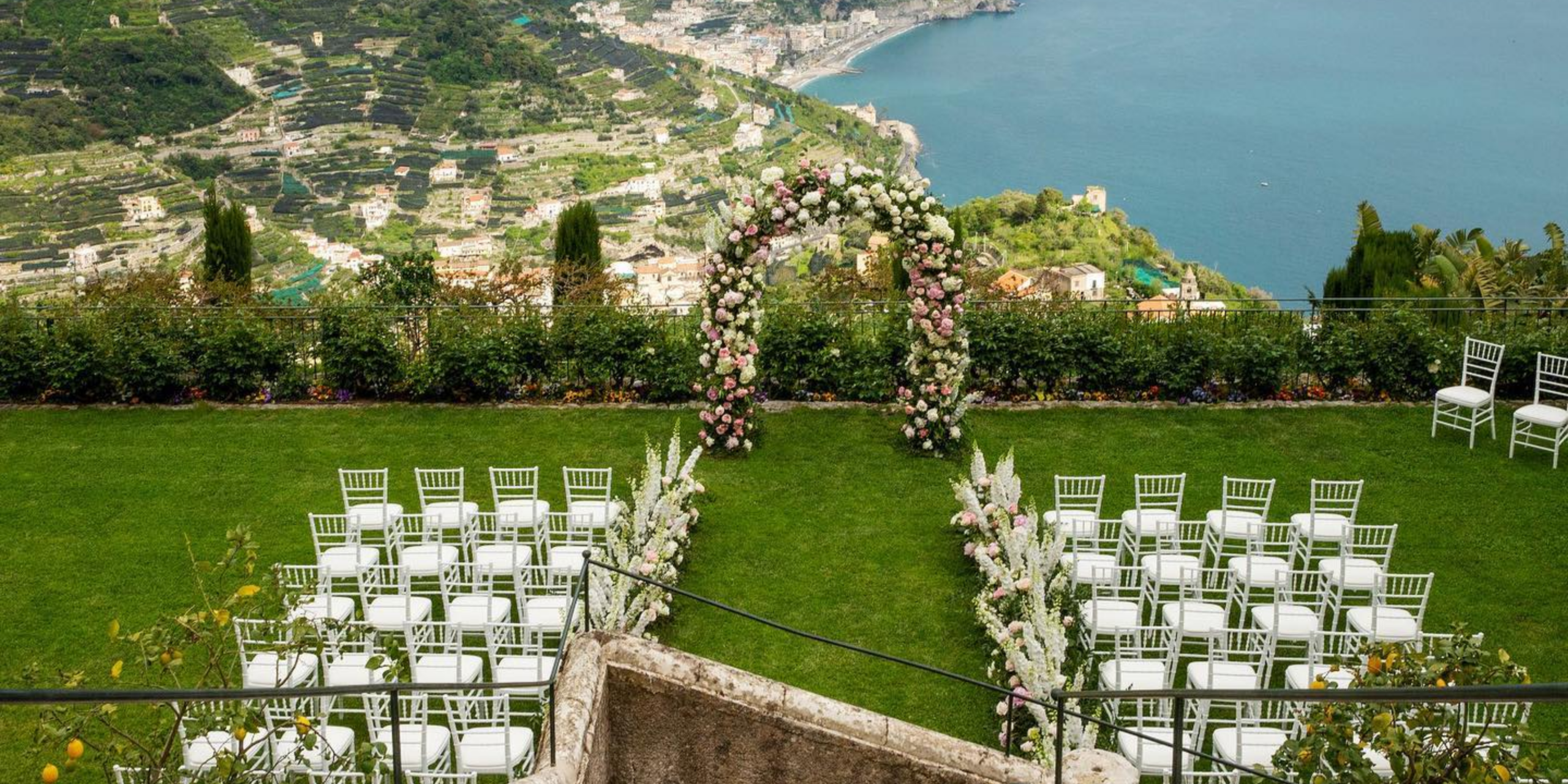 Riviera Maya destination beach wedding ceremony featuring wooden arch, palm trees, ocean backdrop, and neutral design elements inspired by the natural coastal setting