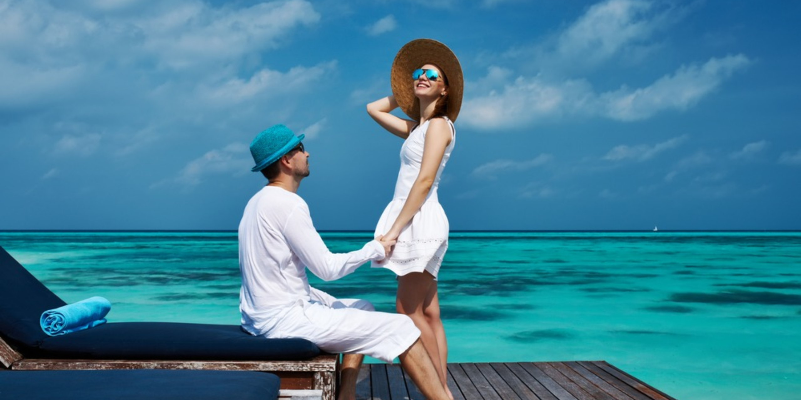 Couple enjoying a peaceful oceanfront honeymoon scene