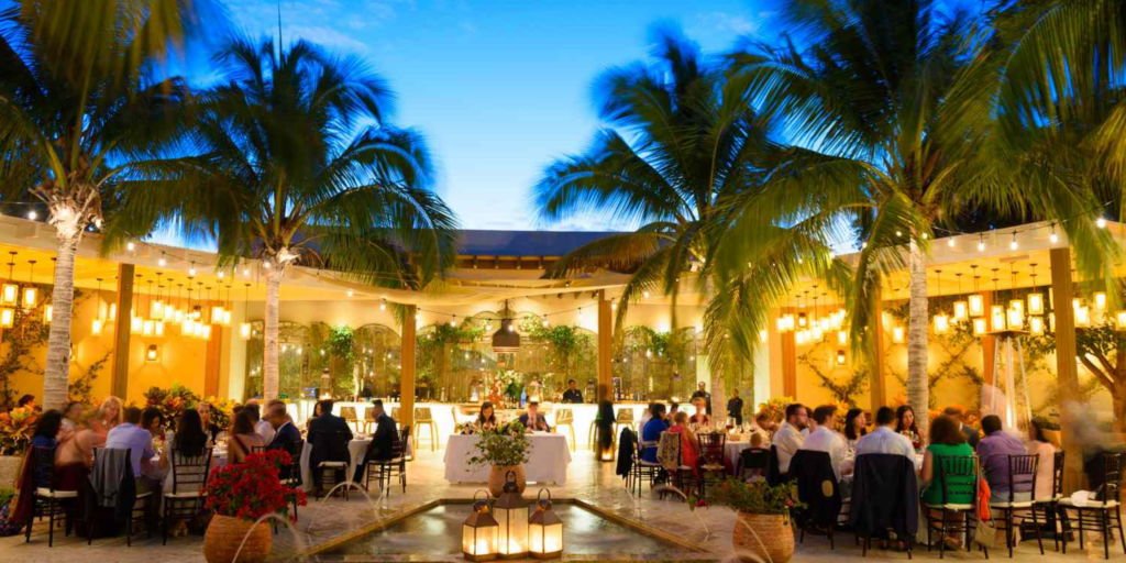Caribbean evening wedding reception with palm trees and candlelight