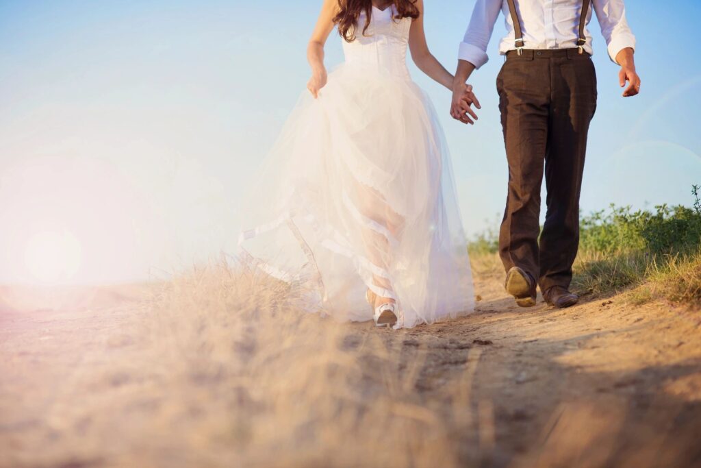 Wedding couple walking on a dirt road