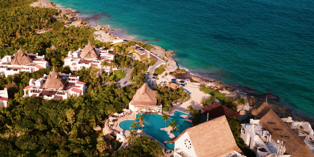 Aerial view of a luxury beachfront resort in Mexico with ocean views and tropical surroundings for destination weddings