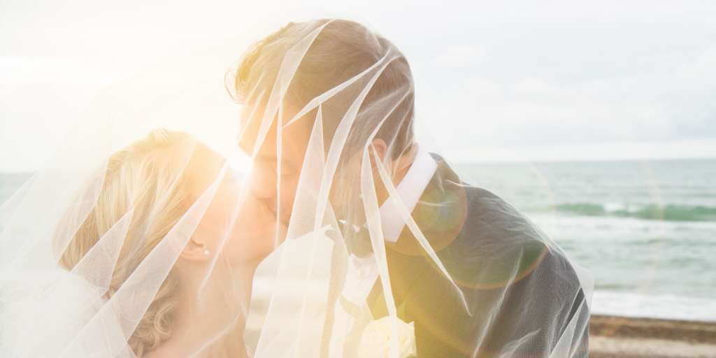 A soft and intimate moment during a beach wedding, made possible when timing allows couples to slow down and connect.