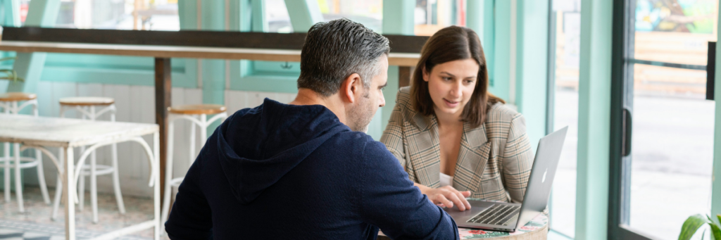Couple reviewing wedding vendor contracts and budget decisions together
