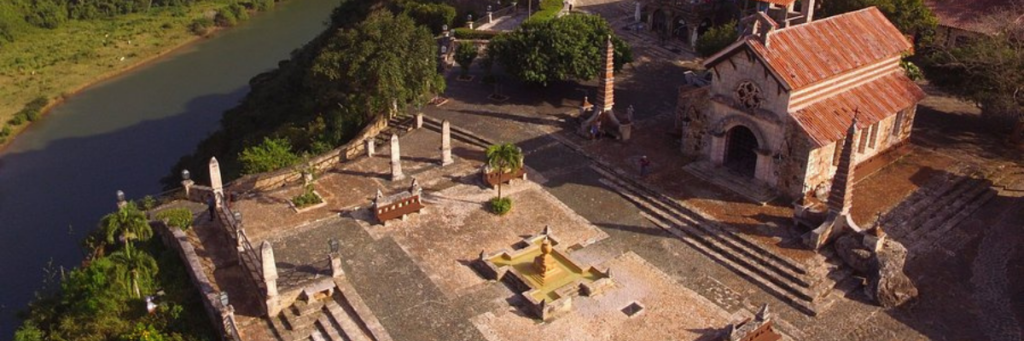 Aerial view of a historic stone wedding venue beside a river in the Dominican Republic.