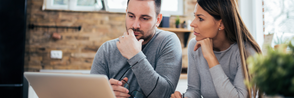 Wedding budget planning, couple reviewing costs together before booking vendors